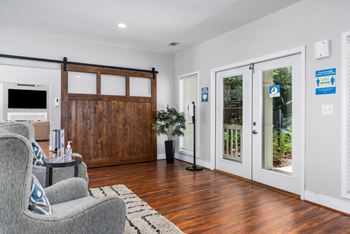 The clubhouse features a barn door to partition the pool table room from the leasing office.